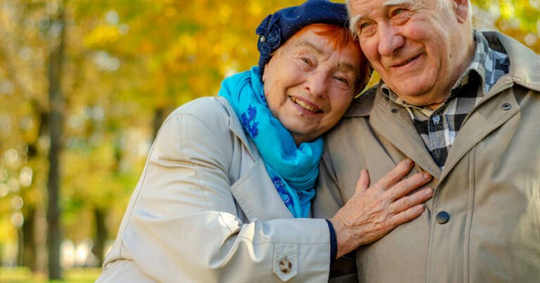 Love lives forever! Senior couple, a very old man and an old woman, hugging and cherishing their time together outdoors.