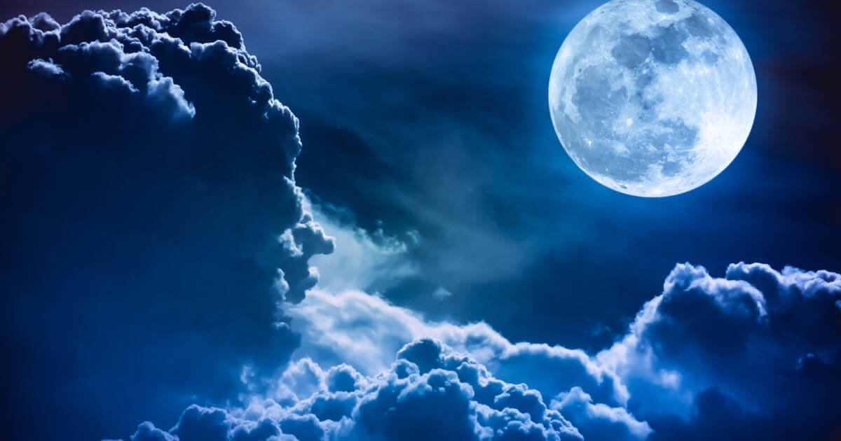 Captivating supermoon in a beautiful night sky with clouds.