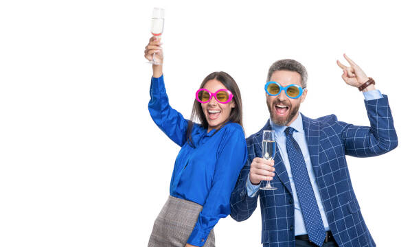 Business partners celebrate success, cheering with champagne and wearing sunglasses