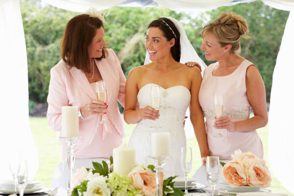 Grandmother, mother, and the bride at her wedding, all enjoying a good time together.