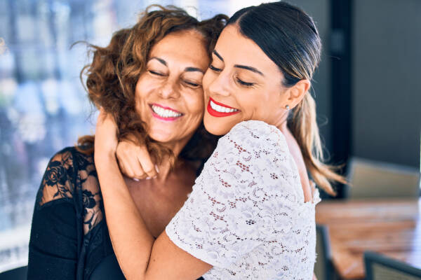 auntie and her niece share a heartwarming hug, capturing a tender moment between them.