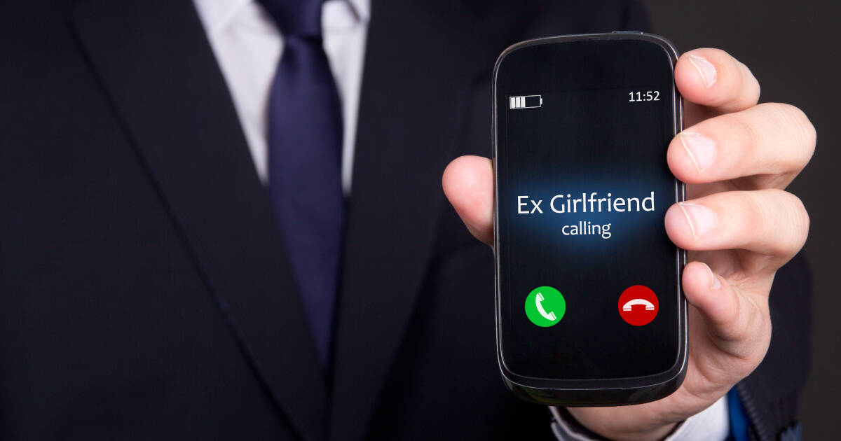 Male hand holds smartphone with incoming call from ex-girlfriend