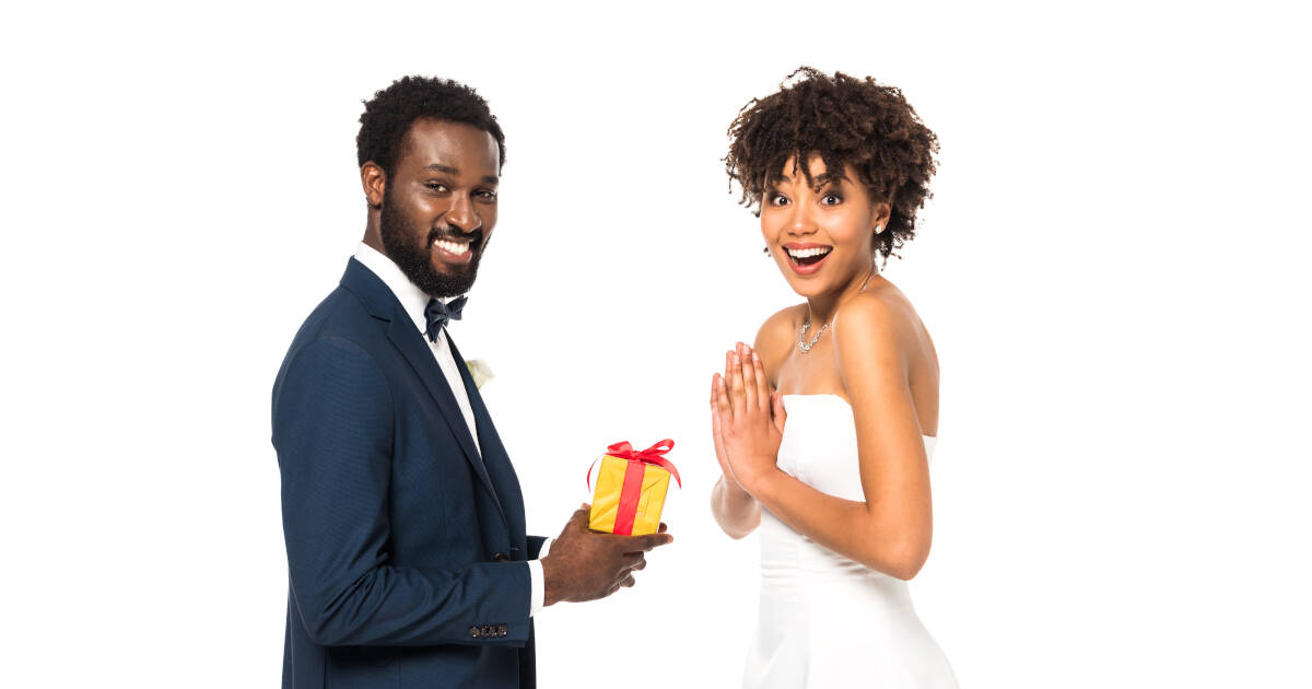 Happy groom Giving Present To Excited Bride.