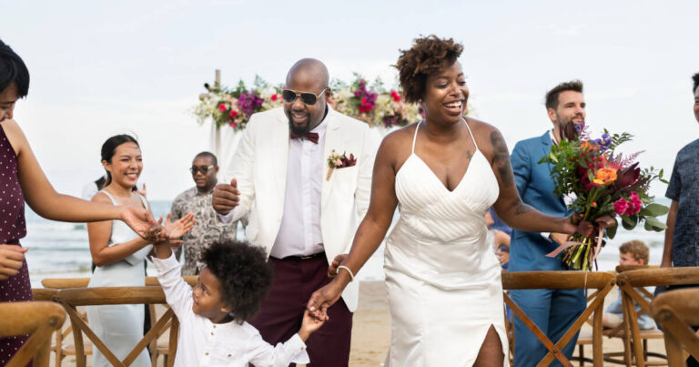 On their wedding day, the couple runs down the aisle with their child as family celebrates.