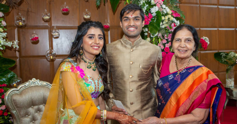 Grandmother heartily congratulates granddaughter and grandson-in-law for their wedding.