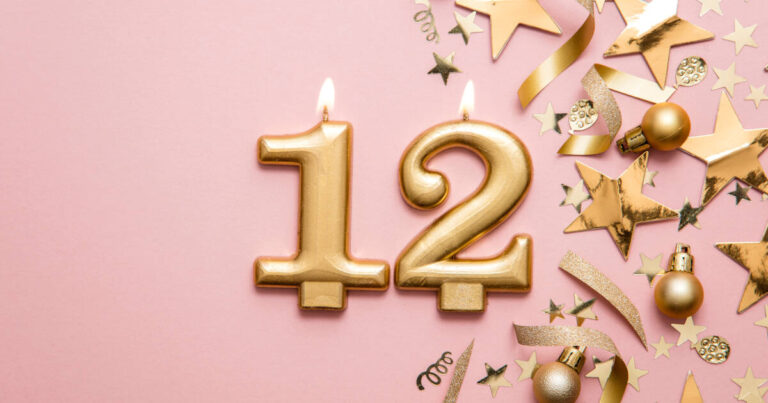 Number 12 Gold Celebration Candle On Star And Glitter Background
